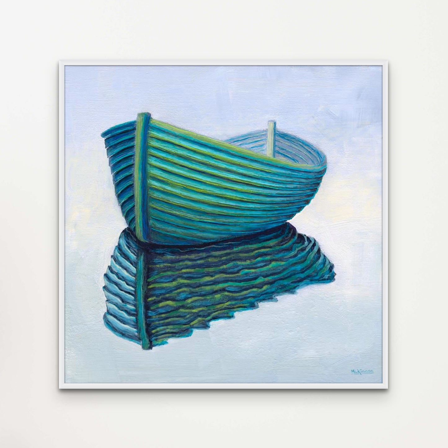 A semi abstract painting of a turquoise, lapstrake rowboat reflected in water on a very light blue background by Canadian artist Catherine McKinnon. This giclee print of the painting is framed in white and mounted on a light grey wall.